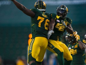 Defensive end Phillip Hunt, right, celebrates a sack with teammate Jabari Hunt during Saturday's game against the Stampeders at Commonwealth Stadium. (Greg Southam)