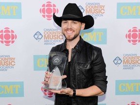 Brett Kissel shows off his hardware at the Canadian Country Music Association Awards on Sunday night. (WENN.COM)