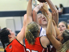 Elaine White of the Mitchell District High School (MDHS) senior girls basketball team is clearly outnumbered on this rebound against Woodstock during action from the MDHS tournament last Friday, Sept. 9. ANDY BADER MITCHELL ADVOCATE