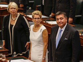Ontario Premier Kathleen Wynne, centre, is flanked by Deb Matthews and Charles Sousa in the legislature at Queen's Park for the reading of the throne speech on Monday, September 12, 2016. (Dave Thomas/Toronto Sun)