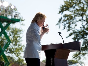 Democratic presidential candidate Hillary Clinton pauses to drink water after coughing as she speaks at the 11th Congressional District Labor Day festival at Luke Easter Park in Cleveland, Ohio, Monday, Sept. 5, 2016. (AP Photo/Andrew Harnik)