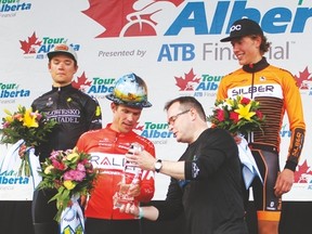 Drayton Valley Mayor Glenn McLean presents race winner Evan Huffman with a painted hard hat and a crystal momento for winning Stage 3 of the Tour of Alberta in Drayton Valley.