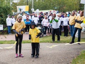 Julia and Elijah Belanger, grandchildren of late-resident Lyla Fee who passed away from ovarian cancer, cut the ribbon to kickstart the 2016 Ovarian Cancer Canada Walk of Hope on Sunday, Sept. 11 The event saw approximately 100 attendees, and raised over $11,000. Taylor Hermiston/Vermilion Standard/Postmedia Network.