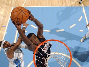 Samuel Dalembert of the Philadelphia 76ers goes to the basket against Carmelo Anthony of the Denver Nuggets at the Pepsi Center January 6, 2008 in Denver. (Garrett Ellwood/NBAE/Getty Images)