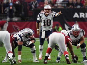 Quarterback Jimmy Garoppolo #10 of the New England Patriots sets up a play against the Arizona Cardinals during the NFL game at University of Phoenix Stadium on September 11, 2016 in Glendale, Arizona. New England won 23-21. (Photo by Ethan Miller/Getty Images)
