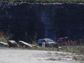 An OPP officer watches over a quarry on Amherst Island after Loyalist Township gained access to the site with a court order on Monday. (Elliot Ferguson/The Whig-Standard)