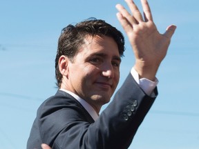 Canadian Prime Minister Justin Trudeau waves to members of the Muslim community as he leaves a mosque in Ottawa, Monday September 12, 2016. THE CANADIAN PRESS/Adrian