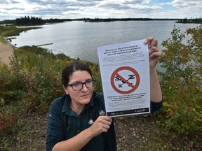 Elk Island National Park, communications officer, Janelle Lane holding a sign that are posted in the park banning drones, actually in all parks, in order to protect the sensitive environment like Elk Island west of Edmonton Monday, September 12, 2016. Ed Kaiser/Postmedia