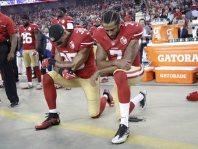 San Francisco 49ers safety Eric Reid and quarterback Colin Kaepernick kneel during the national anthem before an NFL football game against the Los Angeles Rams in Santa Clara, Calif., Monday, Sept. 12, 2016. (AP Photo/Marcio Jose Sanchez)