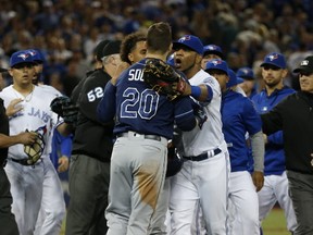 Toronto Blue Jays DH Edwin Encarnacion yells at Tampa Bay Rays Steven Souza Jr. RF to calm down after the loss in which Jays reliever celebrated too soon in Toronto, Ont. on Monday September 12, 2016. (Jack Boland/Toronto Sun/Postmedia Network)