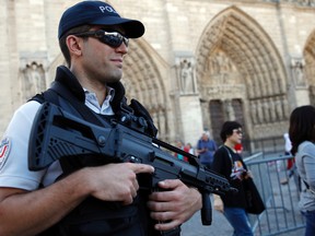 A French police officer patrols in front of Notre Dame cathedral, in Paris, Friday Sept. 9, 2016. A failed attack involving a car loaded with gas canisters near Notre Dame Cathedral was spearheaded a group of women that included a 19-year-old whose written pledge of allegiance to the Islamic State group was found by police, a security official said Friday. (AP Photo/Christophe Ena)