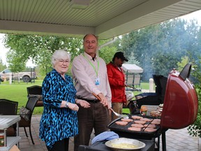 Pat Dorff, LMH board chair, Paul Chatelain CEO MICs  and staffer Eric Mayer were preparing hamburgers for the residents and their family at the Villa Minto barbecue.
