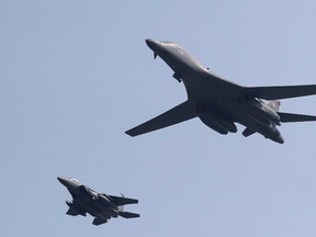 U.S. B-1B bomber, right, flies over Osan Air Base with South Korean Air Forces jet in Pyeongtaek, South Korea, Tuesday, Sept. 13, 2016. The United States has flown nuclear-capable supersonic bombers over ally South Korea in a show of force meant to cow North Korea after its fifth nuclear test and also to settle rattled nerves in the South. (AP Photo/Lee Jin-man)