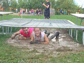 The Lucknow Little Mudder saw slippery slopes, muddy pits and rainbows grace its 4th an final event on Sept. 11, 2016. Both adults and children alike took part in the event, that has raised over $20,000 in the last three years for the Lucknow Agricultural Society, with the final fundraising numbers to tag on thousands more. Pictured: Rob Hamilton and Coral Boyce smile as they slip through the muck during the 'gate crawl'. (Lucknow Little Mudder Facebook Page)