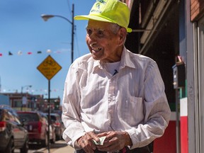 Fidencio Sanchez, smiles after receiving a monetary donation from Elizabeth Salgado, Monday, Sept.12, 2016, in Chicago. What began as a small effort to help out Sanchez, who was spotted pushing a paleta cart and selling the frozen treats to help pay bills has brought in more than $250,000 in just four days. (Alyssa Pointer/Chicago Tribune via AP)