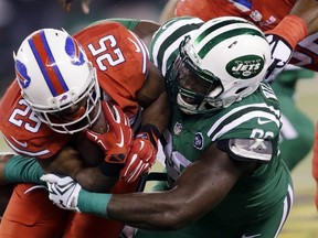 In this Nov. 12, 2015, file photo, Buffalo Bills running back LeSean McCoy, left, is hit by New York Jets defensive end Muhammad Wilkerson during an NFL game in East Rutherford, N.J. (AP Photo/Seth Wenig, File)
