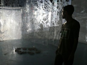 Rui Pimenta, co-artistic director of in/future, walks through the artwork Tuesday, September 13, 2016 ahead of the art and music festival being held at Ontario Place. (Dave Abel/Toronto Sun)