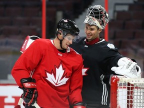 Sidney Crosby (left) of Team Canada shares a laugh with Carey Price (right) during practice at the Canadian Tire Centre in Ottawa on Monday, Sept. 12, 2016. (Jean Levac/Postmedia Network)