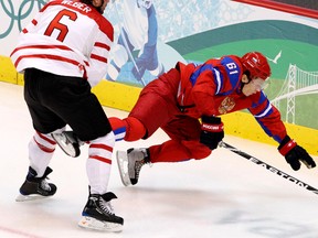 Canada's Shea Weber (left) trips up Russia's Maxim Afinogenov during hockey action at the Vancouver Winter Olympics on Feb. 24, 2010. (Andre Forget/Postmedia Network/Files)