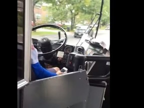 A screengrab from video posted to YouTube of a TTC bus driver using a smartphone while in motion Sept. 8, 2016.