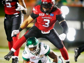 Taylor Reed (3), seen here with the Stampeders celebrating after bringing down quarterback Darian Durant of the Roughriders last month, could face his former team after he signed with the Redblacks on Tuesday. (Al Charest/Postmedia Network)