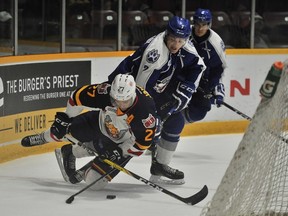 Sudbury Wolves defenceman Reagan O'Grady takes down Barrie Colts centre Cordell James during OHL exhibition action at Barrie Molson Centre earlier this season. Postmedia Network photo