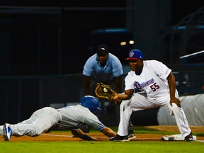 Rockland Boulders' Junior Arrojo dives back to first base as Ottawa Champions first baseman Alexander Malleta catches the throw from the pitcher during the first game of the Can-Am League final at Raymond Chabot Grant Thornton stadium on Tuesday, Sept. 13, 2016. (James Park)