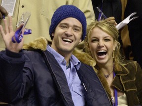 In this Feb. 10, 2002, file photo, Justin Timberlake and Britney Spears wave to the crowd prior to the start of the 2002 NBA All-Star game in Philadelphia. Timberlake told E! News on Sept. 13, 2016, that he's open to collaborating with Spears. (AP Photo/Chris Gardner, File)