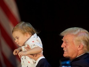 Republican presidential hopeful Donald J. Trump holds Tristan Murphy, 1, following a campaign event with his daughter, Ivanka, at the Aston Township Community Center on September 13, 2016 in Aston, Pennsylvania. Recent national polls show the presidential race is tightening with two months until the election. (Photo by Mark Makela/Getty Images)