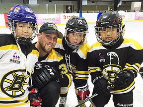 Former Belleville Bulls captain Matt Beleskey of the Boston Bruins shares a moment with youth hockey players during a Bruins-sponsored instructional trip to China this summer. (Boston Bruins photo)