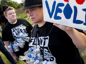 Flint resident Maegan Wilson, right, joins dozens gathered to protest Republican presidential candidate Donald Trump's visit on Wednesday, Sept. 14, 2016, outside of the Flint Water Plant in Flint, Mich. ( Jake May/The Flint Journal-MLive.com via AP)