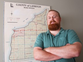 County of Lambton worker Greg Spiridonov is pictured here with a map of the municipality at the county administration building Wednesday. The 34-year-old geographic information system (GIS) specialist will receive an Ontario Provincial Police Commissioner's Letter of Commendation -- one of the highest honours bestowed by the provincial police -- for his assistance in the Noelle Paquette homicide investigation. (Barbara Simpson/Sarnia Observer/Postmedia Network)
