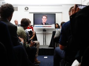 Edward Snowden is seen on a television screen via video uplink from Moscow during a news conference to call upon President Barack Obama to pardon Snowden before he leaves office, Wednesday, Sept. 14, 2016, in New York. Human and civil rights organizations, including the ACLU, Human Rights Watch and Amnesty International, launched a public campaign to persuade Obama to pardon the former National Security Agency contractor, who leaked classified details in 2013 of the U.S. government's warrantless surveillance program before fleeing to Russia. (AP Photo/Mary Altaffer)
