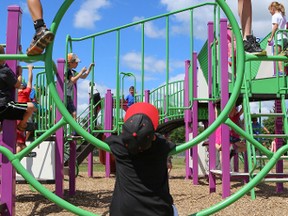 Tim Miller/Intelligencer file photo
Students from Georges Vanier Catholic School hang out on a schoolyard play structure on Wednesday June 29, 2016 in Belleville. Starting September 2017 schools will be required to provide before and after school care for students.