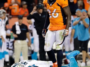 Carolina Panthers quarterback Cam Newton lies on the turf after a roughing the passer penalty was called on Denver Broncos free safety Darian Stewart. (AP Photo/Joe Mahoney, File)