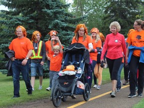 Participants in a fundraising event for Muscular Dystrophy Canada walk to raise awareness of and raise money for the organization, which strives to support those who are impacted by more than 150 neuromuscular diseases.