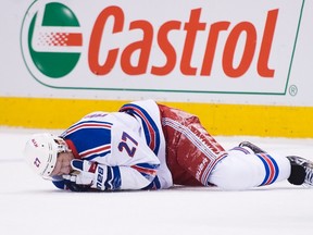 Rangers defenceman Ryan McDonagh lays injured on the ice after taking a hit to the head by Maple Leafs centre Leo Komarov during NHL action in Toronto last season. (Nathan Denette/The Canadian Press/Files)