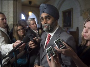 FILE - Minister of National Defence Minister Harjit Sajjan speaks with the media before Question Period on Parliament Hill in a June 15, 2016, file photo. Sajjan says the navy's submarines play a critical role in Canada's defence. But he says no decision has been made on what to do with the four vessels as the clock ticks down on their useful lives. THE CANADIAN PRESS/Adrian Wyld, File