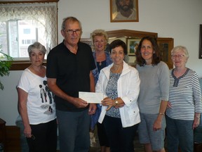 Past Grand Knight Steve Yawney presents a cheque to Mary Ali, middle, executive director of Inner City Home, and Inner City Home counsellor Darla Barnes. Also in photo are volunteers Addie O'Kane, left, and Lenora Bray and Merle Walter. Supplied photo