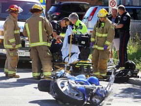 Frontenac paramedics and Kingston firefighters aid an injured motorcyclist involved in a  collision at the intersection of Montreal and Bay streets in Kingston, Ont. on Thursday, Sept. 15, 2016.
Elliot Ferguson/The Whig-Standard/Postmedia Network