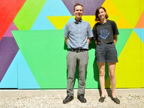 Aaron McMillan (left), director of the Dundas Street Festival, and Tegan Moore, the festival’s visual arts co-ordinator, stand in front of a mural on Dundas Street on London Ont. September 7, 2016. CHRIS MONTANINI\LONDONER\POSTMEDIA NETWORK