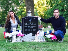 Alisha Tackaberry and Marc Gemperle are seen at the Oakland Cemetery gravesite of their son Graysen. (Submitted photo)