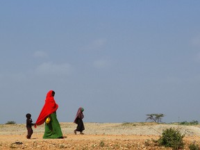 A woman and her children walk to the Transit Centre to find water in Dolo Ado, Ethiopia, on December 15, 2011. WILLIAM DAVIES/AFP/Getty Images)