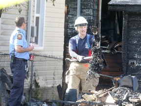 Firefighters examine a fire scene on Aberdeen Avenue on Thursday morning, hours after fires broke out at three different homes. (Chris Procaylo/Winnipeg Sun)