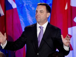 Ontario Progressive Conservative leader Tim Hudak announces that he will be stepping down as party leader after being defeated at his election night campaign head quarters in Grimsby June 12, 2014. (THE CANADIAN PRESS/Nathan Denette)