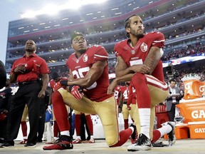 In this Monday, Sept. 12, 2016, file photo, San Francisco 49ers safety Eric Reid (35) and quarterback Colin Kaepernick (7) kneel during the national anthem before a game against the Los Angeles Rams in Santa Clara, Calif. (AP Photo/Marcio Jose Sanchez, File)