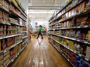 An employee walks past a well-stocked aisle at the Old East Village Grocer, a newly opened full-service grocery store offering a solution to the ?food desert? plaguing the area near Dundas and Adelaide streets in London. (CRAIG GLOVER, The London Free Press)