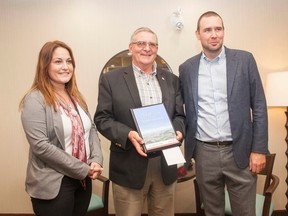 Vermilion Mayor Bruce McDuff presents Pomeroy Inn and Suites' General Manager Tannis Frantik and President Ryan Pomeroy a business plaque, on behalf of the Town of Vermilion, on Wednesday, September 14, 2016, in Vermilion, Alta. Taylor Hermiston/Vermilion Standard/Postmedia Network.