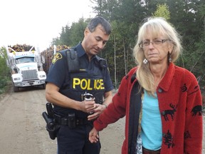 Clyde McNichol/For The Sudbury Star
Barbara Ronson McNichol is arrested by an OPP officer at the site of a logging operation near Benny in this file photo. She was charged with mischief for blocking a truck.