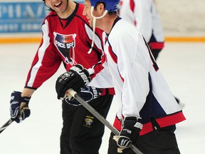 Fernando Pisani, in white, shown here skating with Jason Strudwick at a 2013 charity event, will work with the Oil Kings forwards. (File)